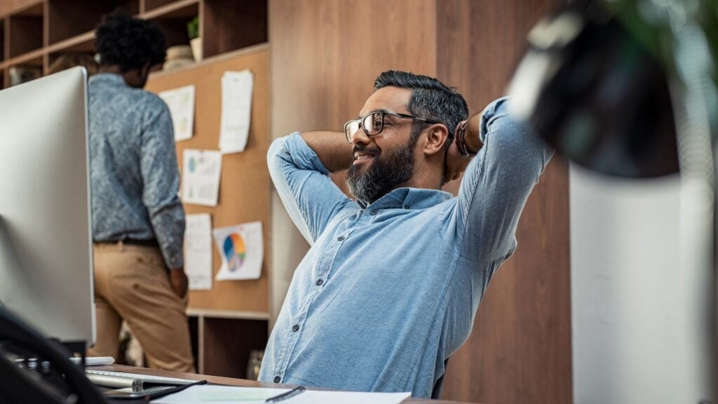 how to beat burnout in IT workers worker appearing relaxed at desk