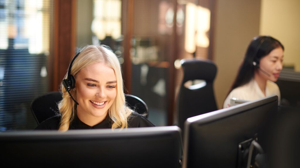 image of two female computer workers in office for what are co-managed IT services? blog featured image