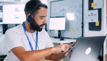 Help desk worker providing technical support at computer